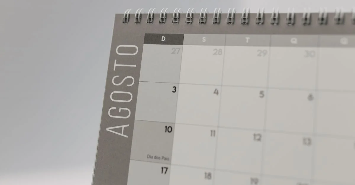 Primer plano de un calendario con encuadernación espiral resaltando las fechas de agosto.