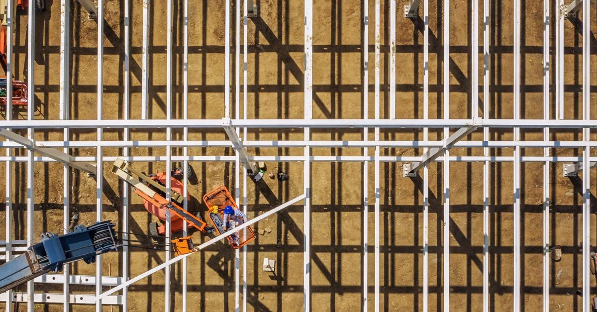 Imagen aérea de un sitio de construcción en Brasil que muestra estructuras de metal y maquinaria.